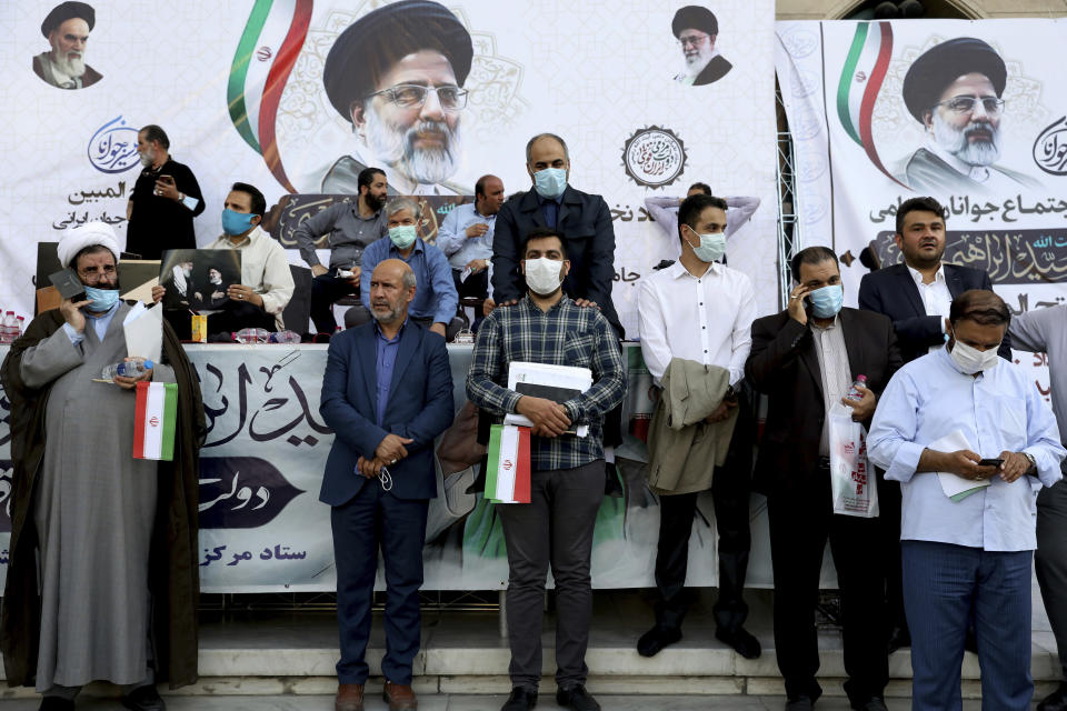 Supporters of presidential candidate Ebrahim Raisi attend a rally in Tehran, Iran, Wednesday, June 16, 2021. Iran's clerical vetting committee has allowed just seven candidates for the Friday, June 18, ballot, nixing prominent reformists and key allies of President Hassan Rouhani. The presumed front-runner has become Ebrahim Raisi, the country's hard-line judiciary chief who is closely aligned with Supreme Leader Ayatollah Ali Khamenei. (AP Photo/Ebrahim Noroozi)