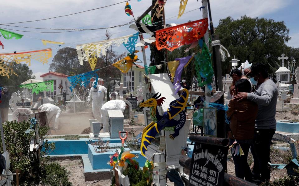 Workers complete the burial of a man, who died from coronavirus at San Efren Municipal Cemetery - Reuters