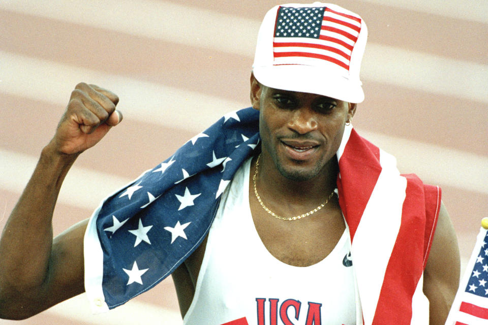 FILE - In this Aug. 6, 1992, file photo, Kevin Young, of the United States, celebrates his world record performance in the 400-meter hurdles at the XXV Summer Olympics in Barcelona, Spain. For nearly three decades, Kevin Young has been waiting to pick up the phone and congratulate someone. This year, he might finally have to. The 53-year-old holds one of the oldest world records in track _ 46.78 seconds in the 400-meter hurdles. At the world championships this year, there's a good chance it might get broken. (AP Photo/Denis Paquin, File)