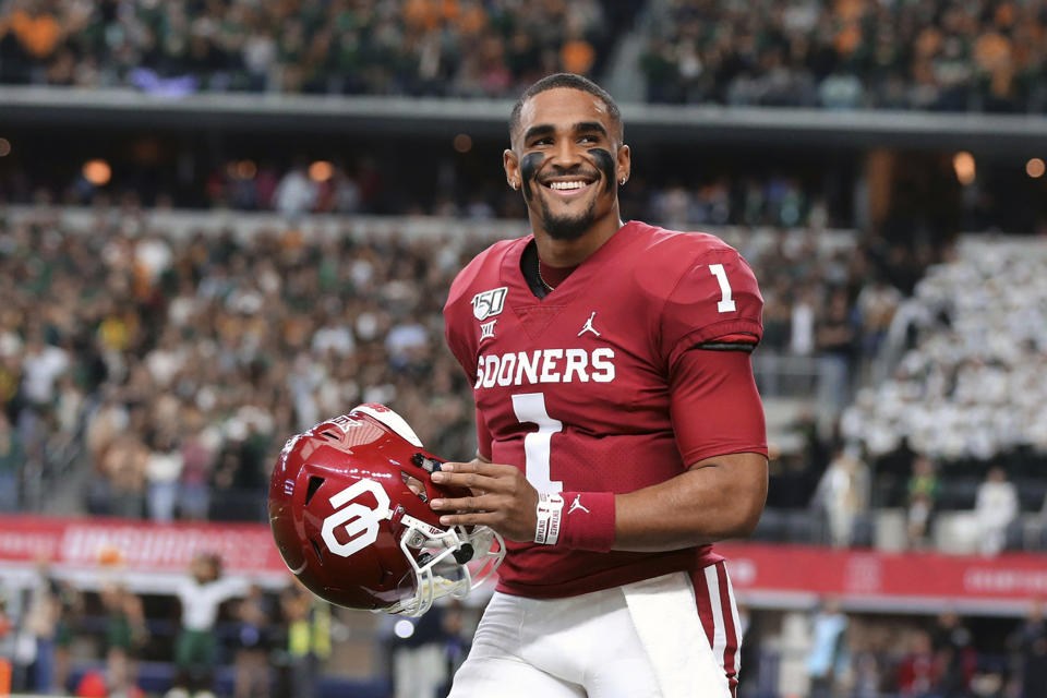 FILE - In this Dec. 9, 2019, file photo, Oklahoma quarterback Jalen Hurts smiles on the sidelines before an NCAA college football game against Baylor for the Big-12 championship, in Arlington, Texas. Hurts, the Heisman Trophy runner-up who once starred for Alabama, is hoping to improve his NFL draft stock at the Senior Bowl. (Rod Aydelotte/Waco Tribune Herald, via AP, File)