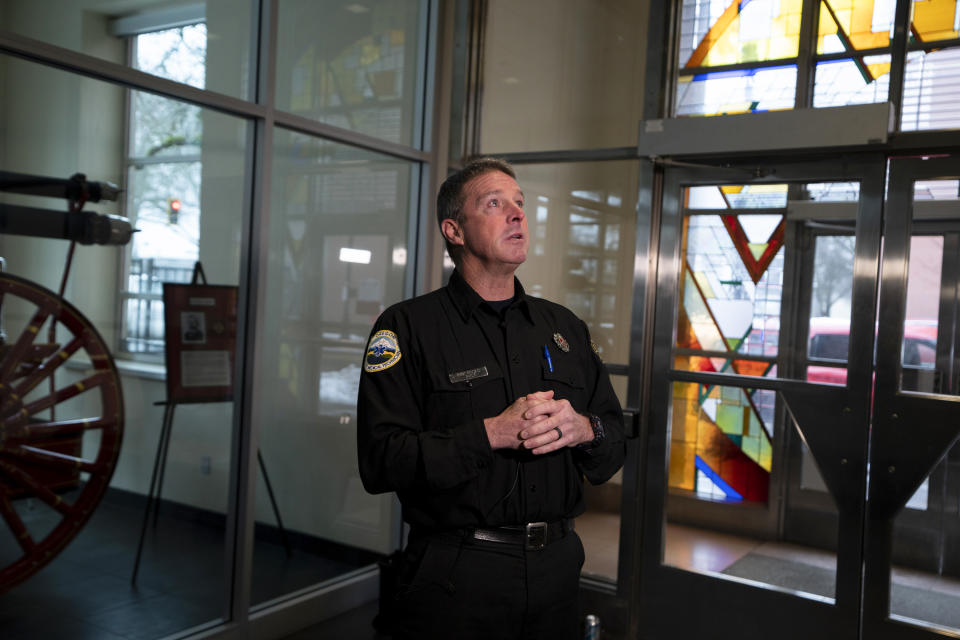 Portland Fire and Rescue spokesman Rick Graves speaks to members of the media before a news conference at the Portland Fire & Rescue headquarters on Thursday, Jan. 18, 2024, in Portland, Ore. A power line fell on a parked car in northeast Portland, Oregon, on Wednesday, killing three people and injuring a baby during an ice storm. (AP Photo/Jenny Kane)