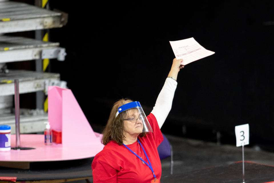PHOENIX, AZ - MAY 01: A contractor working for Cyber Ninjas, who was hired by the Arizona State Senate, works to recount ballots from the 2020 general election at Veterans Memorial Coliseum on May 1, 2021 in Phoenix, Arizona.  / Credit: COURTNEY PEDROZA / Getty Images