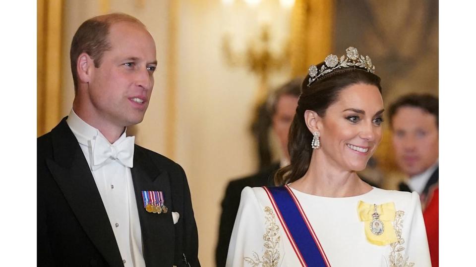 Close-up of William wearing a white tuxedo and Kate in a white gown and tiara 