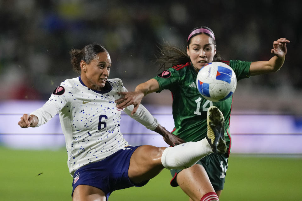 FILE - U.S. forward Lynn Williams, left, and Mexico defender Greta Espinoza vie for the ball during a CONCACAF Gold Cup women's soccer tournament match, Monday, Feb. 26, 2024, in Carson, Calif. Forward Catarina Macario won't be able to train for the Olympics because of irritation in her right knee, U.S. coach Emma Hayes announced on Friday, July 12, 2024. Macario will be replaced on the roster by alternate Lynn Williams, pending approval by the U.S. Olympic Committee, FIFA and the International Olympic Committee. (AP Photo/Ryan Sun, File)