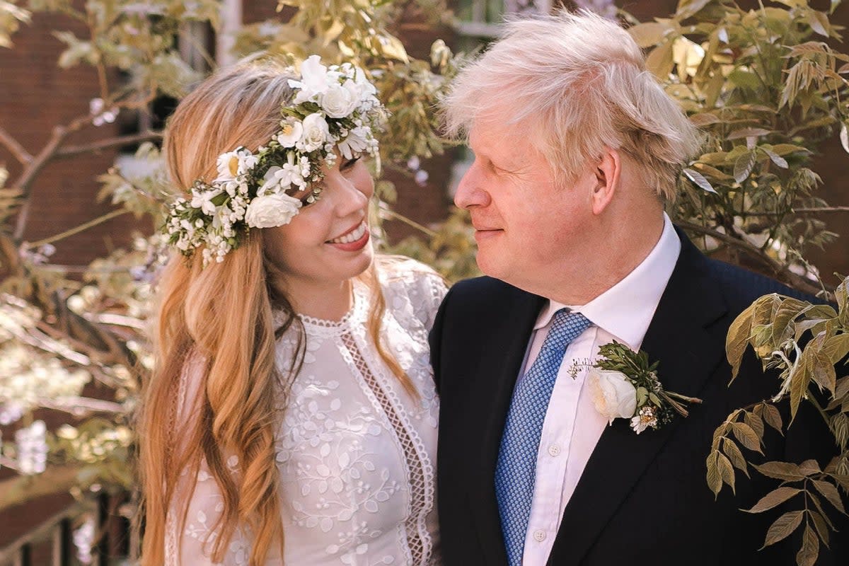 Boris Johnson poses with his wife Carrie Johnson in the garden of 10 Downing Street, following their wedding at Westminster Cathedral on 29 May 2021 (Downing Street via Getty)