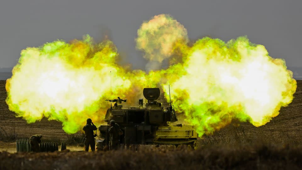 An IDF Artillery solider covers his ears as a shell is fired toward Gaza on October 11, near Netivot, Israel.  - Alexi J. Rosenfeld/Getty Images