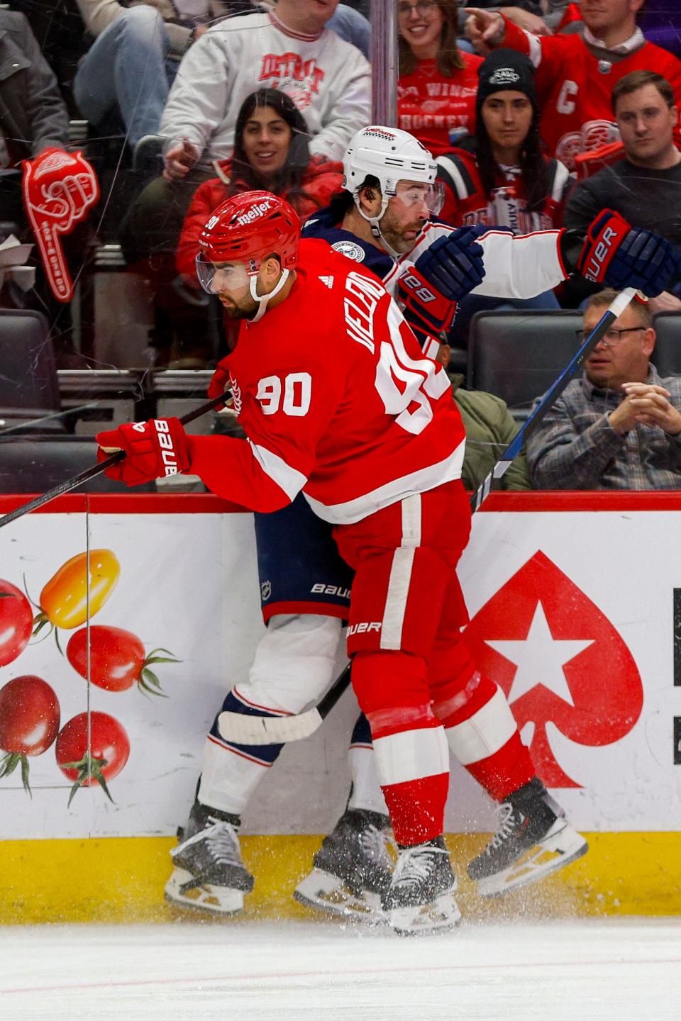 Red Wings center Joe Veleno checks Blue Jackets defenseman Erik Gudbranson into the boards during the first period on Tuesday, March 19, 2024, at Little Caesars Arena.