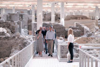 In this handout photo provided by the Prime Minister's Office, Greek Culture Minister Lina Mendoni, left, walks next to Greek Prime Minister Kyriakos Mitsotakis during their visit in the archaeological site of Akrotiri at the Greek island of Santorini, Saturday, June 13, 2020. Mitsotakis visited Santorini Saturday to announce the opening of the tourist season. (Dimitris Papamitsos/Greek Prime Minister's Office via AP)