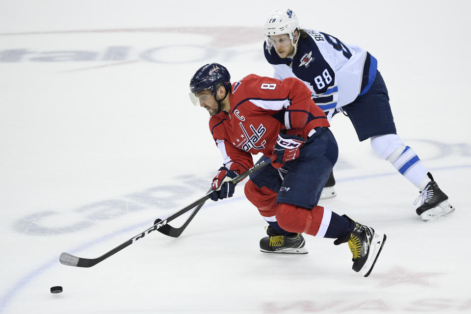 Washington Capitals left wing Alex Ovechkin (8), of Russia, skates with the puck against Winnipeg Jets defenseman Nathan Beaulieu (88) during the third period of an NHL hockey game, Sunday, March 10, 2019, in Washington. The Capitals won 3-1. (AP Photo/Nick Wass)