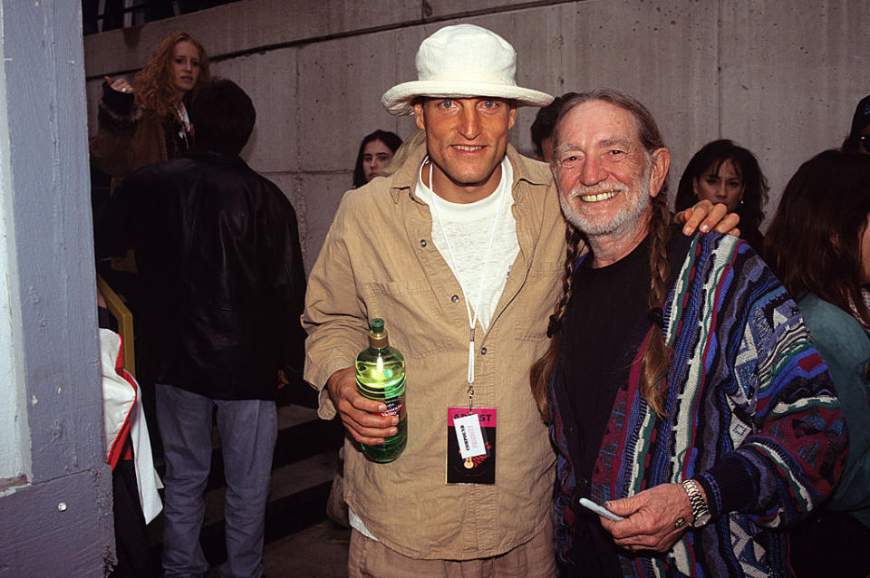 Willie Nelson and Woody Harrelson attend Farm Aid on Oct. 3, 1998, at New World Music Theater in Tinley Park, Ill. (Photo: Ebet Roberts/Redferns) 