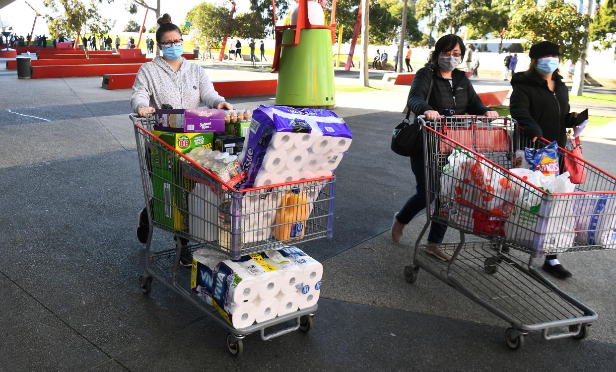 People push their trolleys outside a Costco outlet in Melbourne on August 2, 2020 as shoppers queue for provision with the Victorian state government expected to annouce harsh new restrictions due to the city battling fresh outbreaks of the COVID-19 coronavirus. (Photo by William WEST / AFP) (Photo by WILLIAM WEST/AFP via Getty Images)