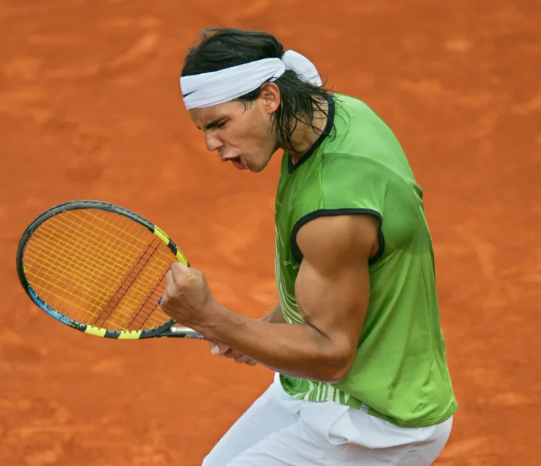 A teenage Nadal celebrates after winning his first ever match at the French Open against Lars Burgsmuller