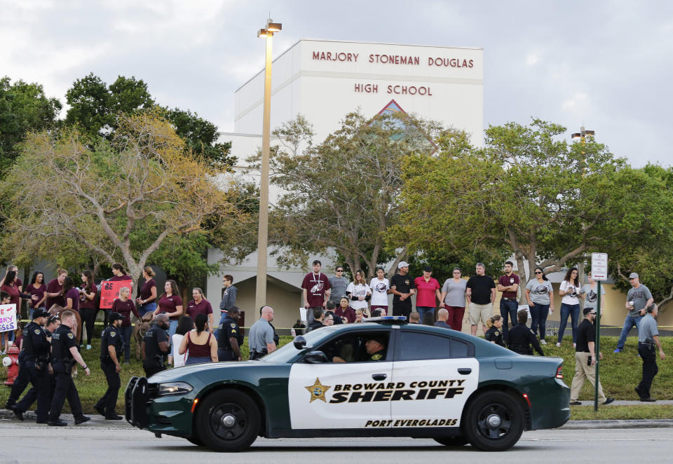 FILE - In this Feb. 28, 2018 file photo, a police car drives near Marjory Stoneman Douglas High School in Parkland, Fla., as students return to class for the first time since a former student opened fire there with an assault weapon. Mass shootings at schools have prompted a growing number of states to encourage the creation of digital maps of facilities to aid emergency responders. An Associated Press analysis found that governors and lawmakers in more than 20 states have enacted or proposed measures setting standards for digital school mapping. (AP Photo/Terry Renna, File)