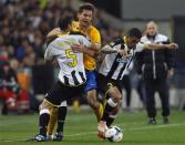 Juventus' Fernando Llorente (C) fights for the ball with Udinese's Danilo Larangeira (L) and Allan Loreiro during their Italian Serie A soccer match at the Friuli stadium in Udine April 14, 2014. REUTERS/Alessandro Garofalo