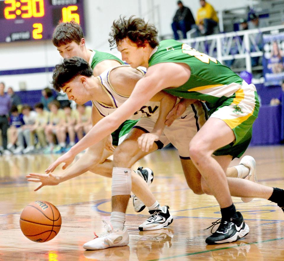 Routt Catholic's Kellen Creviston scoops up a loose ball during the game against Brown County Friday, February 9, 2024.