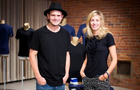 Kit and Ace owners J.J. Wilson and Shannon Wilson pose in their flagship store in Vancouver, British Columbia in this file photo taken on October 17, 2014. REUTERS/Ben Nelms