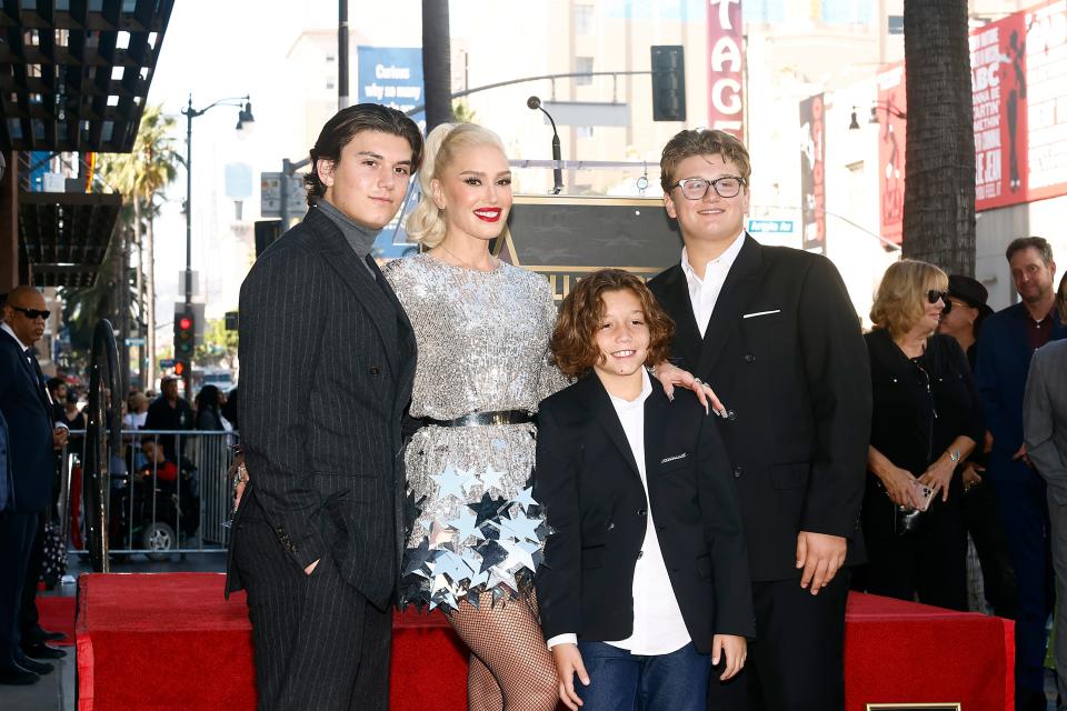 Gwen Stefani poses with children Kingston Rossdale (left), Apollo Rossdale (2nd from right) and Zuma Rossdale at her Hollywood Walk of Fame Star Ceremony on Oct. 19, 2023.