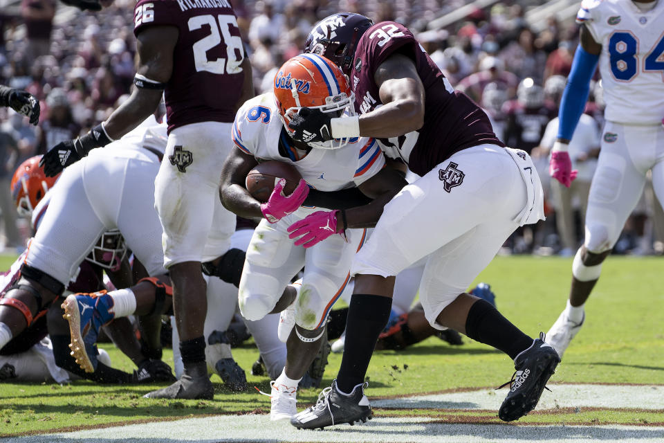 Florida running back Nay'Quan Wright (6) fights his way past Texas A&M linebacker Andre White Jr. (32) for a touchdown during the second quarter of an NCAA college football game, Saturday, Oct. 10, 2020, in College Station, Texas. (AP Photo/Sam Craft)