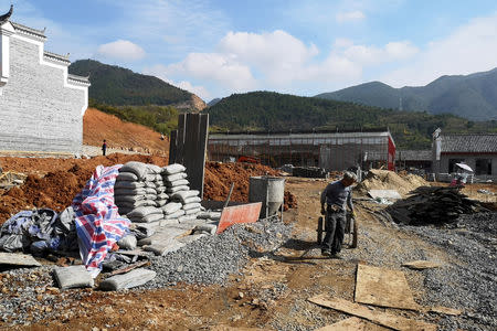 A man works at the construction site of a 'red tourism' attraction featuring Chinese Communism, in Shazhou village, Rucheng county, Hunan province, China December 3, 2018. Picture taken December 3, 2018. REUTERS/Shu Zhang