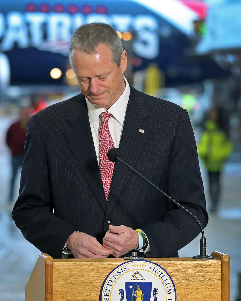 Massachusetts governor Charlie Baker speaks to the press on Thursday in front of a plane that delivered masks from China.