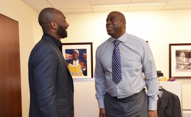Kobe Bryant and Magic Johnson converse in Lakers offices. (Getty)