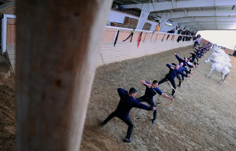 Students of Lajos "The Master" Kassai practice archery at the 'Valley' in Kaposmero village, south Hungary on March 7, 2015