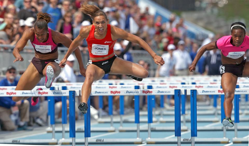 Lolo Jones, center, strides over a hurdle in the women 100 meter hurdles at the Drake Relays in 2013. This week, Jones announced she intends to take part in the relays again in 2024.