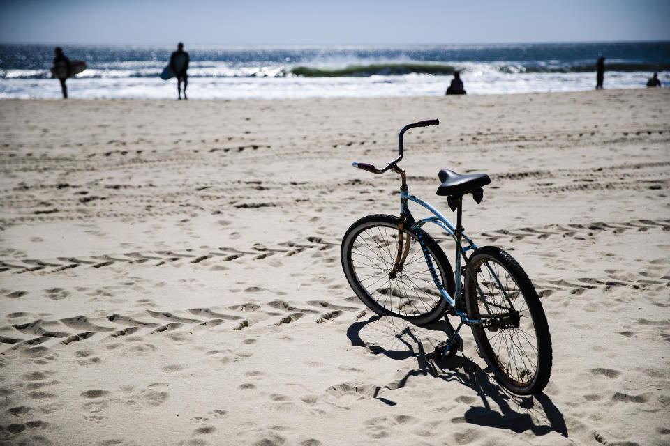 FILE - In this May 2, 2020, file photo, a bicycle sits in the sand during the coronavirus pandemic in Belmar, N.J. (AP Photo/Matt Rourke, File)