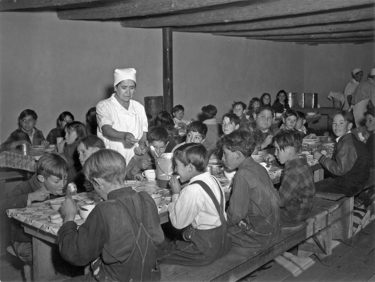 Image: Schoolchildren eat hot school lunches made up primarily of food from the surplus commodities program at a school in Peñasco, N. M. in December 1941. (USDA)