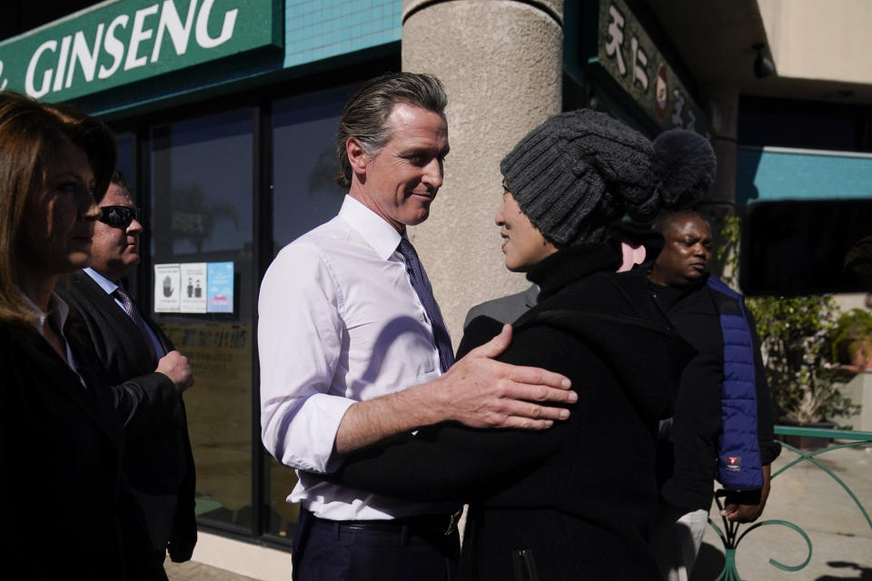 California Gov. Gavin Newsom talks to a local resident in Monterey Park, Calif., Monday, Jan. 23, 2023. (AP Photo/Jae C. Hong)