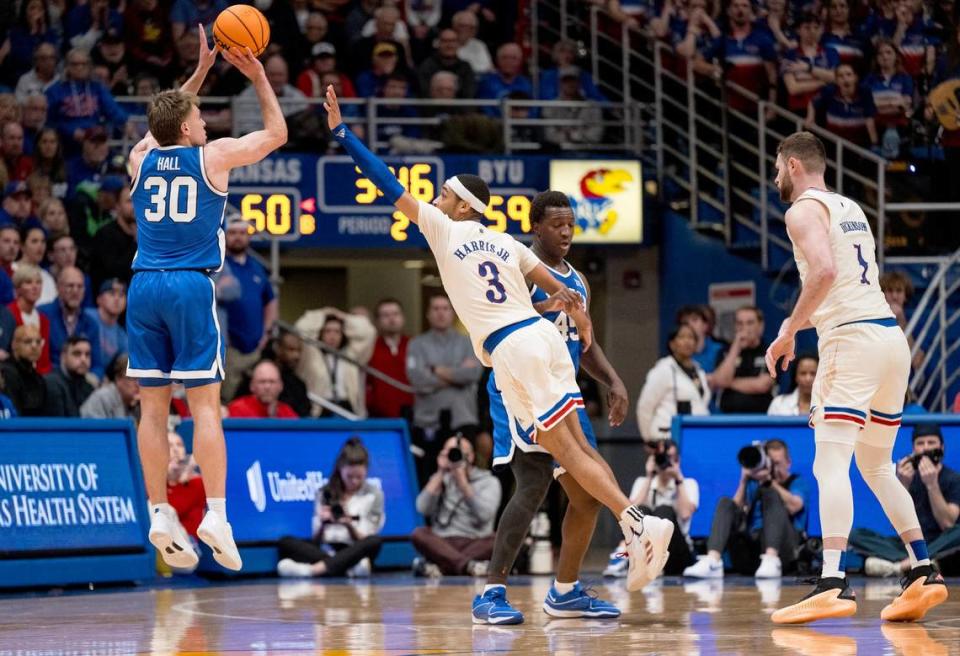 BYU guard Dallin Hall (30) shoots over Kansas guard Dajuan Harris Jr. (3) during a game on Feb. 27 in Lawrence, Kansas. The Cougars won 76-68.