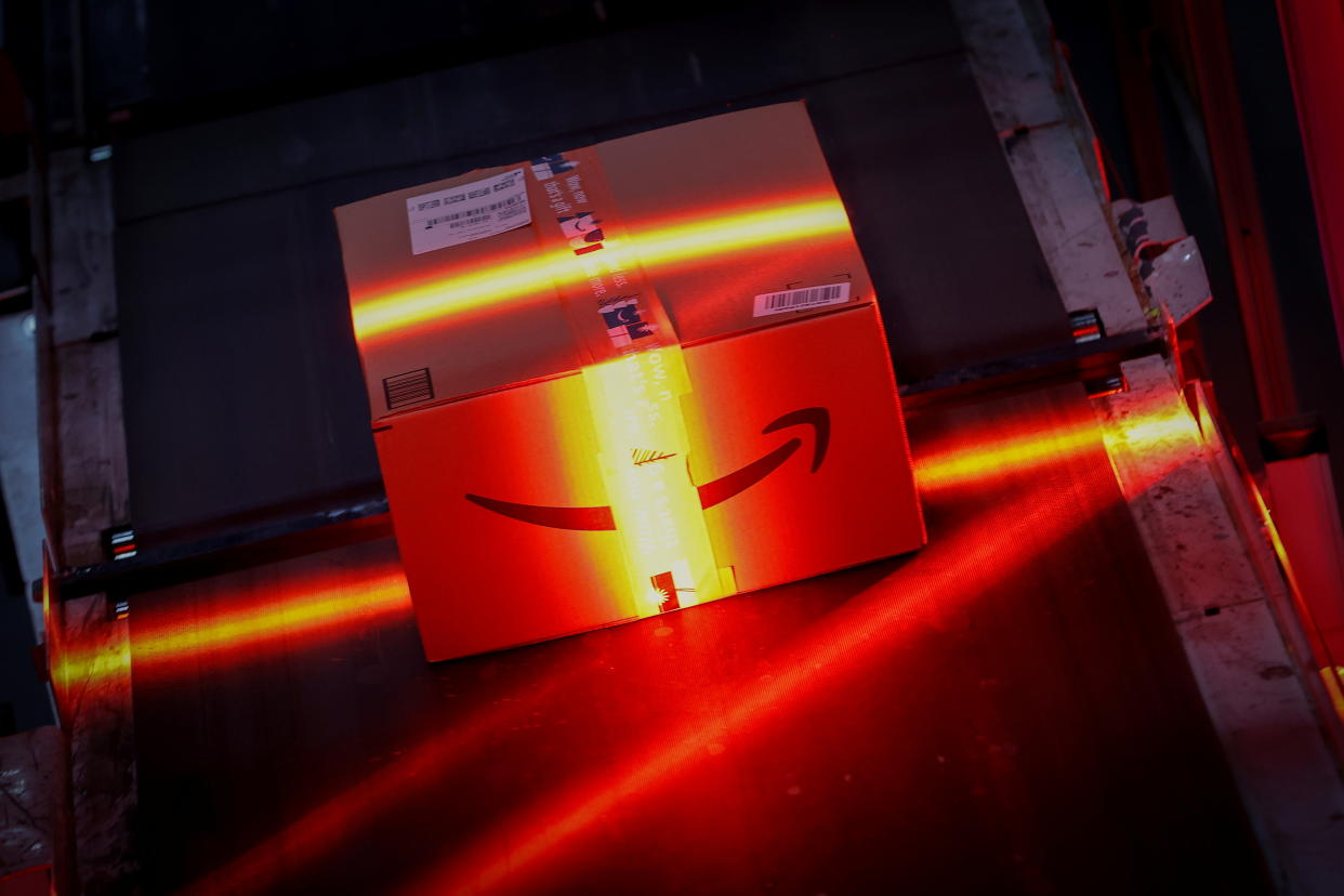 A fast-moving conveyor moves a package through a scanning machine on its way to a delivery truck during operations on Cyber Monday at Amazon's fulfillment center in Robbinsville, New Jersey, U.S., November 29, 2021. REUTERS/Mike Segar     TPX IMAGES OF THE DAY