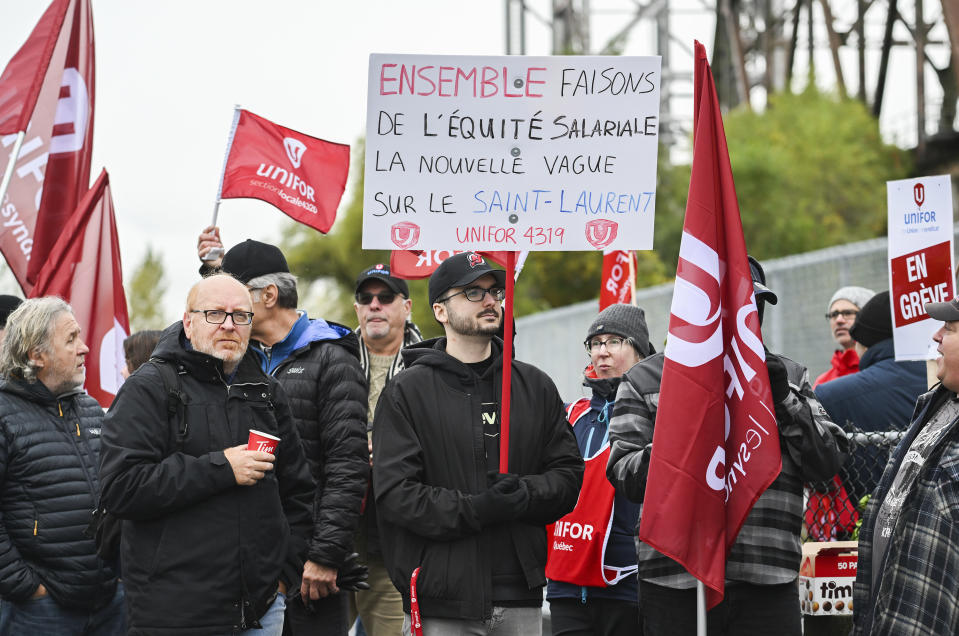 Striking St. Lawrence Seaway workers picket outside the St. Lambert Lock in St. Lambert, Quebec, Monday, Oct. 23, 2023. A strike has shut down all shipping on the St. Lawrence Seaway, interrupting exports of grain and other goods from Canada and the United States via the Great Lakes to the world.(Graham Hughes/The Canadian Press via AP)