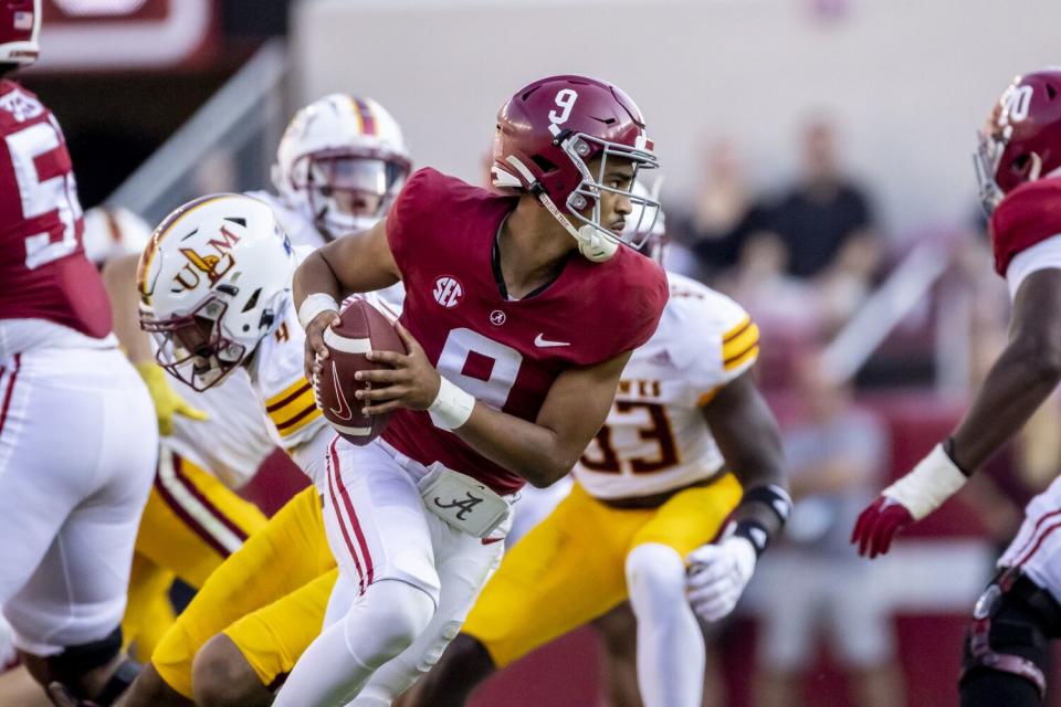 Alabama quarterback Bryce Young rolls out on a pass play.