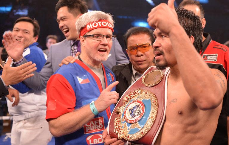 Manny Pacquiao (R) celebrates a victory in Las Vegas in 2014 with his trainer for the last 15 years Freddie Roach