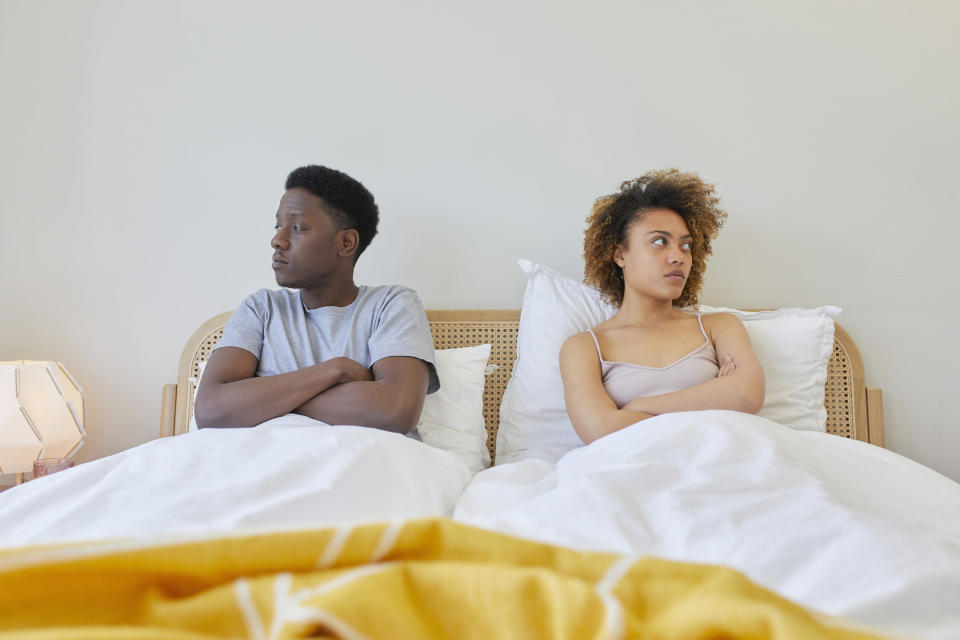 couple in bed looking the other way