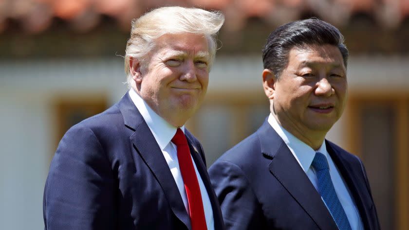 FILE - In this April 7, 2017, file photo President Donald Trump and Chinese President Xi Jinping walk together after their meetings at Mar-a-Lago in Palm Beach, Fla. Trump won cheers during the presidential campaign by attacking China for allegedly stealing American jobs and failing to use its influence to stop ally North Koreaâ€™s nuclear drive. But as president Trump has cozied up to Chinaâ€™s Xi Jinping.(AP Photo/Alex Brandon, File)