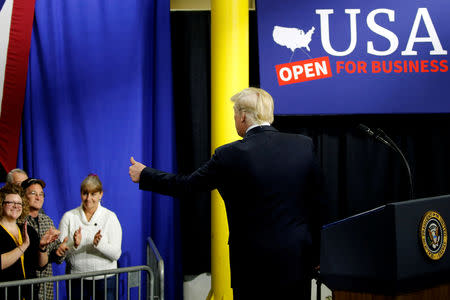 FILE PHOTO: U.S. President Donald Trump gives supporters a thumbs-up as he takes the stage to deliver remarks on his tax policy after a factory tour of the Sheffer Corporation in Blue Ash, Ohio, U.S. February 5, 2018. REUTERS/Jonathan Ernst/File Photo