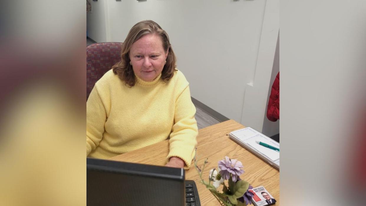 Kelly Gomes is shown at her desk in the constituency office of Brendan Maguire, the MLA for Halifax Atlantic. Gomes was recently attacked in the office. She said she was saved by a student on a work term who intervened. (Codie Dionne - image credit)