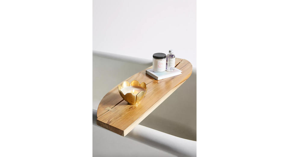 Designed to mimic a smooth sheet of wood, this bath caddy is simple, elegant and functional.