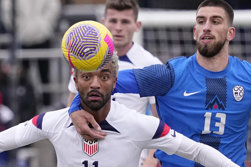 United States midfielder Timmy Tillman (11) is grabbed by Slovenia midfielder Adrian Zeljkovic (13) as he tries to field a pass during the first half of an international friendly soccer match in San Antonio, Saturday, Jan. 20, 2024. (AP Photo/Eric Gay)