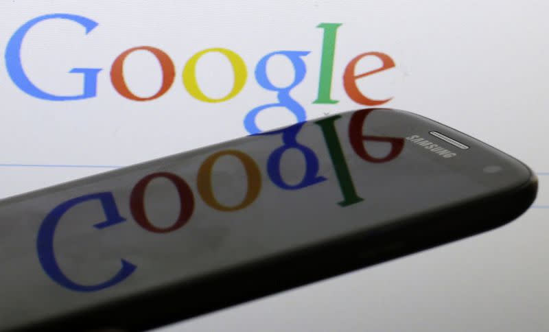A Google logo is reflected on the screen of a Samsung Galaxy S4 smartphone in this photo illustration taken in Prague January 31, 2014. REUTERS/David W Cerny/Files