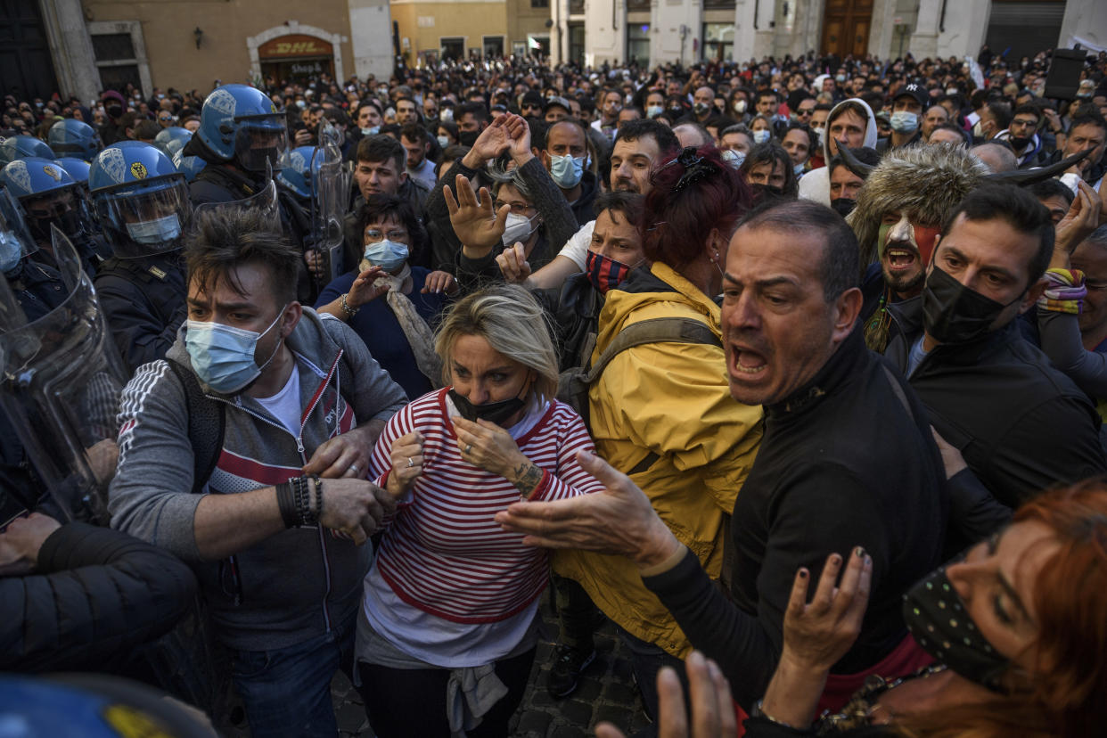 People clash with anti-riot police