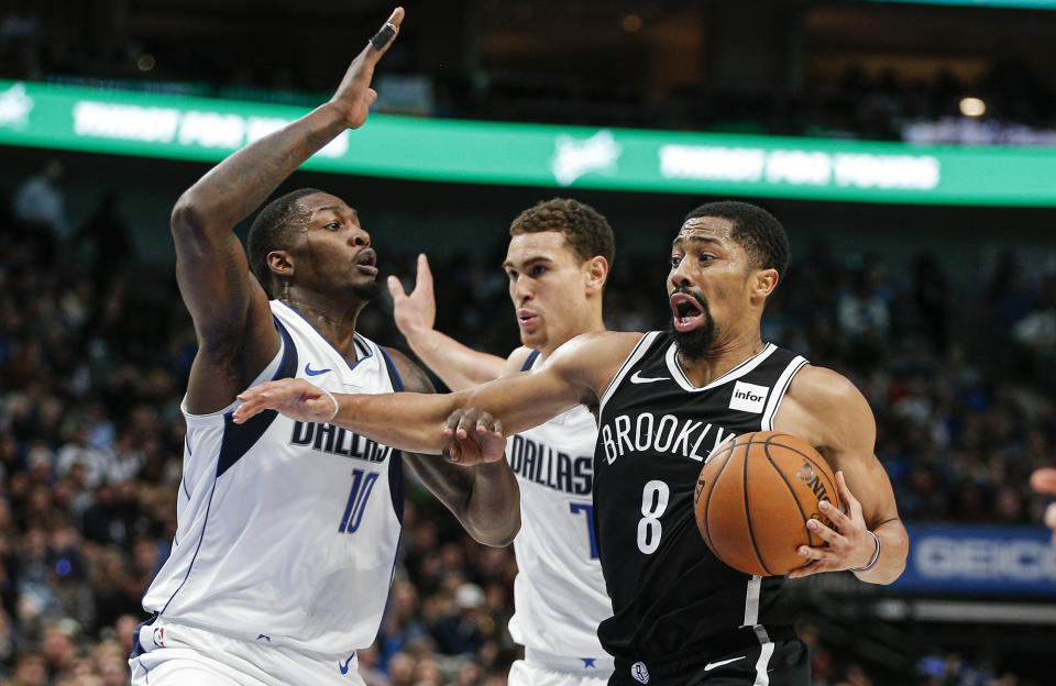 Brooklyn Nets guard Spencer Dinwiddie (8) works against Dallas Mavericks forwards Dorian Finney-Smith (10) and Dwight Powell (7) during the second half of an NBA basketball game Thursday, Jan. 2, 2020, in Dallas.(AP Photo/Brandon Wade)