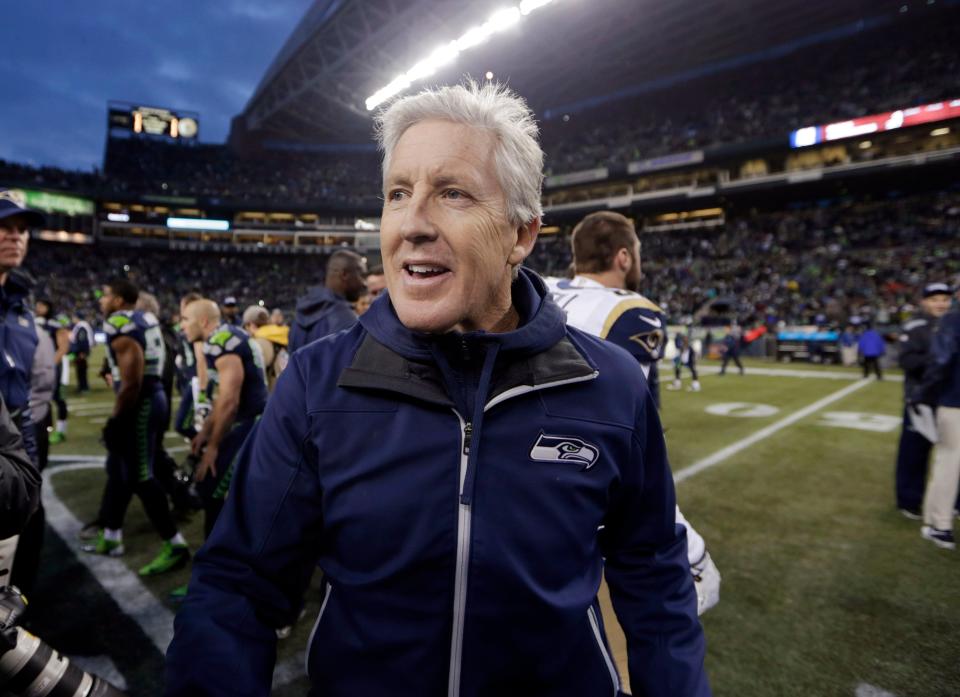 Seattle Seahawks head coach Pete Carroll walks off the field after the Seahawks beat the St. Louis Rams 27-9 in an NFL football game, Sunday, Dec. 29, 2013, in Seattle. (AP Photo/John Froschauer)