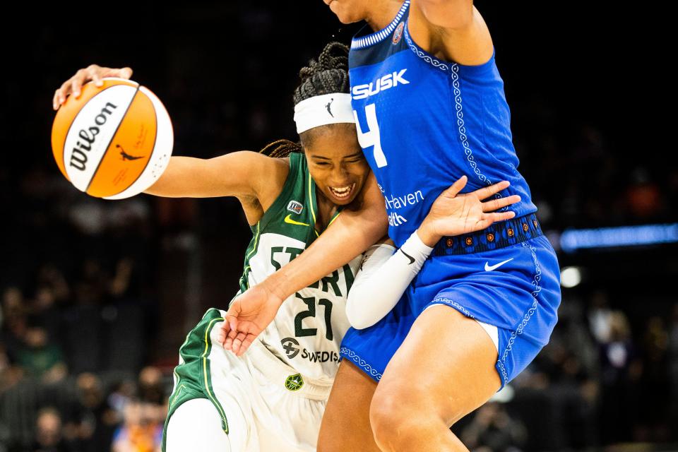 Seattle Storm guard Jordin Canada (21) drives the ball and defends against Connecticut Sun forward Stephanie Jones (4) at the Seattle Storm vs. Connecticut Sun inaugural WNBA Commissioner's Cup final at the Footprint Center in Phoenix, Aug. 12, 2021.