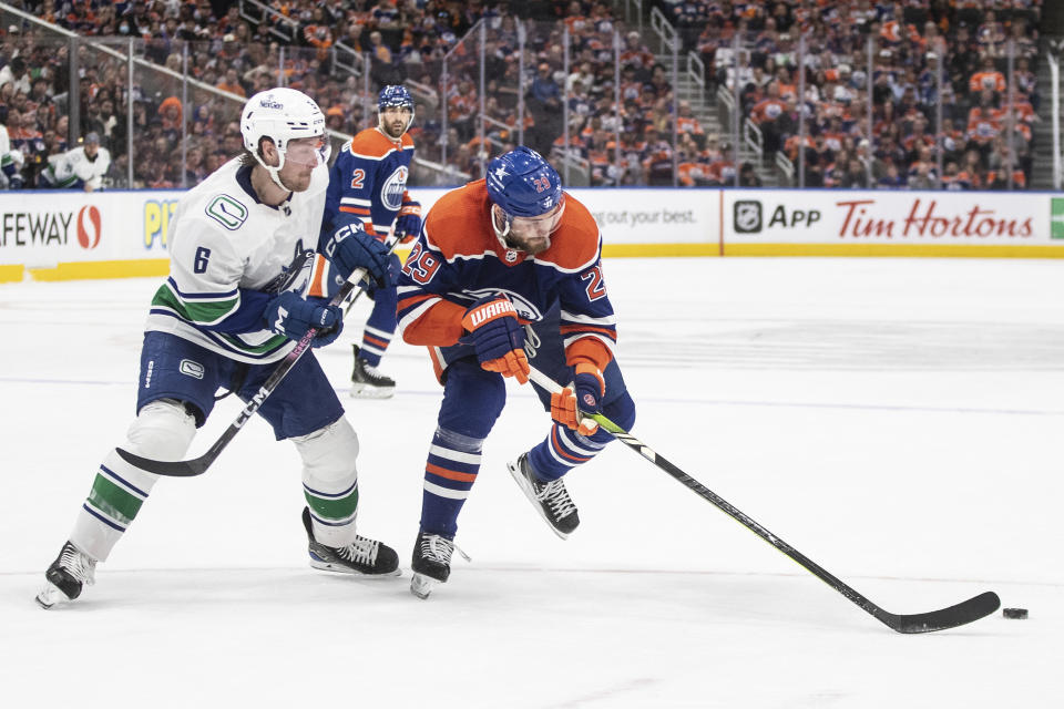 Vancouver Canucks' Brock Boeser (6) chases Edmonton Oilers' Leon Draisaitl (29) during the second period of Game 3 of an NHL hockey Stanley Cup second-round playoff series in Edmonton, Alberta, Sunday, May 12, 2024. (Jason Franson/The Canadian Press via AP)