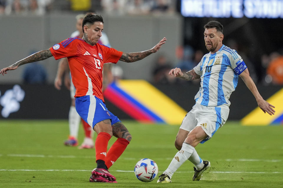 Argentina's Lionel Messi, right, and Chile's Erick Pulgar vie for the ball during a Copa America Group A soccer match in East Rutherford, N.J., Tuesday, June 25, 2024. (AP Photo/Julia Nikhinson)