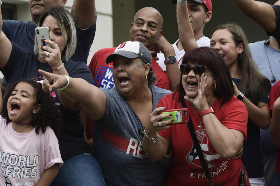 Fans celebrate Boston Red Sox manager Alex Cora's arrival to his hometown with the 2018 World Series trophy, accompanied by Chairman Tom Werner and President and CEO Sam Kennedy, as well as seven Red Sox players and coaches, in Caguas, Puerto Rico, Saturday, Nov. 3, 2018. (AP Photo Carlos Giusti)