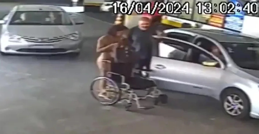 Surveillance video shows Érika de Souza Vieira Nunes in a parking lot of a Rio de Janeiro bank after bringing her dead uncle by rideshare cab to sign financial documents. Jam Press Vid